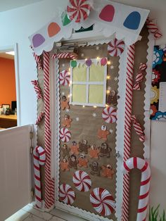 a door decorated with candy canes and gingerbreads on it's side