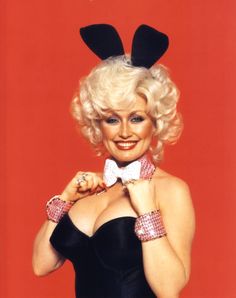 a woman with blonde hair wearing a black dress and bow tie posing for the camera