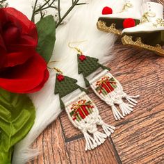 the earrings are decorated with red and green beads, which have tassels on them