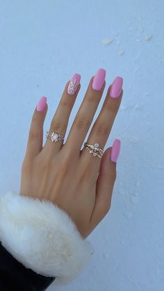 a woman's hand with pink and white nail polish holding onto a fur coat