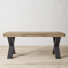 a wooden table with two metal legs and a white wall in the backround