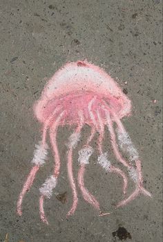 a pink jellyfish chalk drawing on the sidewalk