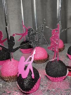 cupcakes with pink frosting and black decorations