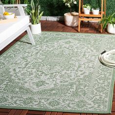 an outdoor area rug with a hose hooked up to it