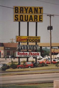 an image of a store front with cars parked in the parking lot and signs on the building