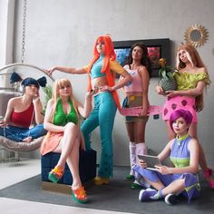 several women dressed in costumes posing for the camera