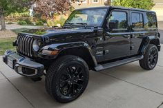 a black jeep parked in front of a house