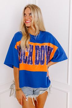 - Show off your team spirit in this dazzling oversized 'TOUCHDOWN' tee! Featuring a sequined design and chic unfinished seam accents, you'll shine on game day. Show your team spirit with our vibrant clothing collection inspired by the bold colors of popular college football teams like the Auburn Tigers and the University of Florida Gators. - Unlined lightweight material with unfinished seam accents - A sequined 'TOUCHDOWN' design across the front - Short drop sleeves - An oversized silhouette th Vibrant Clothing, College Football Teams, Touch Down, Football Teams, Auburn Tigers, University Of Florida, Florida Gators, Oversized Silhouette, Shine On