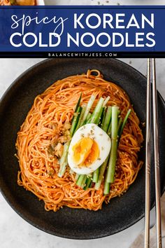 a bowl filled with noodles and an egg on top, next to chopsticks