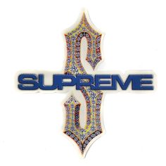 a sticker with the word supreme on it and an ornate cross in the middle