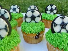 cupcakes with green frosting and soccer balls on them