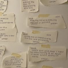 several pieces of paper with words written on them are pinned to the side of a wall