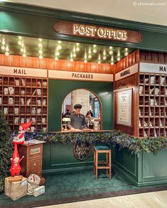 the post office is decorated in green and brown with christmas lights on it's ceiling