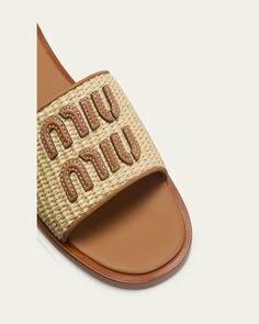 Miu Miu woven raffia sandals with leather trim    0.17 in / 5 mm flat heel    Open toe    Wide band upper with logo lettering    Slide style    Leather outsole    Lining: Leather    Made in Italy Brown Designer Sandals With Woven Sole, Miu Miu Open Toe Sandals For Summer, Luxury Leather Miu Miu Sandals, Designer Sandals With Woven Straw Sole, Miu Miu Designer Open Toe Sandals, Designer Beach Sandals With Textured Sole, Luxury Open Toe Sandals By Miu Miu, Designer Beige Sandals With Woven Sole, Designer Woven Leather Beach Sandals