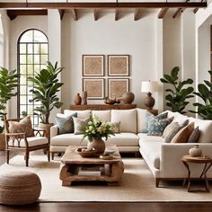 A cozy living room with a white sectional sofa, wooden coffee table, green plants, and decorative pillows in blue shades. Colonial Interiors Modern, Modern Traditional Spanish Interior Design, Charleston Sc Decorating Style, Tropical Coastal Interior, Traditional Farmhouse Interior Design, South African Home Decor, Colonial Chic Interior Design, Contemporary Colonial Interiors, Key West Interior Design