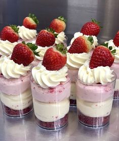 there are many desserts with strawberries on top of each other in small cups