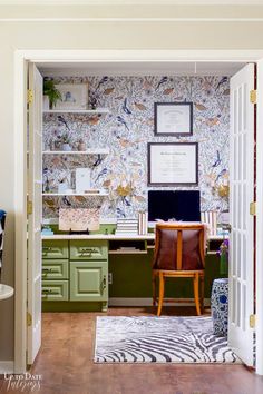 an open door leading into a room with wallpaper on the walls and pictures above it