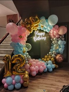 balloons and streamers are arranged in the shape of a arch for a 21st birthday party