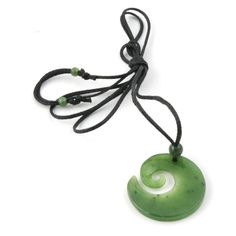 Koru Pendant carved out of solid jade. A striking Jade Pendant. Inspired by Maori designs. Threaded on a braided waxed cord, comes complete with a Hand Crafted Wooden Display Box.Comes on an adjustable cord 14" to 28"Available in 2 sizes 20mm and 27 mm.Pendant Meaning:Spiral - KoruThe fern fronds represent life, new beginnings, life unfolding, growth and harmony. The stylization of the Koru represents the spirit of rejuvenation. Adjustable Green Carved Necklace, Adjustable Green Carved Necklaces, Wooden Display Box, Jade Charm, Maori Designs, Fern Frond, Wooden Display, Nephrite Jade, Jade Carving