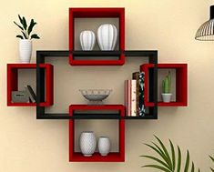 the shelves are red and black with some white vases on each shelf in front of them