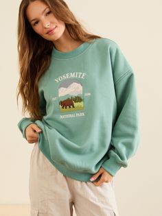 Featuring a detailed embroidered Yosemite National Park graphic, this cozy piece is perfect for layering or wearing on its own. The soft, breathable fabric ensures comfort, while the classic pullover style offers a timeless look. National Park Graphic, Football Dress, Football Tops, Retro Sweatshirts, Comfy Tops, Embroidered Sweatshirt, Yosemite National, Yosemite National Park