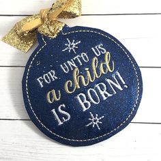 a blue ornament with the words for unto us as child is born on it