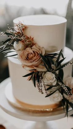 a white wedding cake with flowers on top