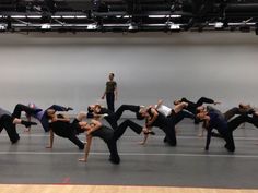 a group of people doing yoga poses in a gym