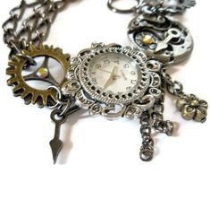 This beautiful steampunk watch bracelet is a unique art piece for the purveyor of eclectic and  sophisticated hand-crafted artisan jewelry. Steampunk is a unique style that combines the  Victorian look with a cog and steam powered industrial revolution look. The effect is certainly  unique and eye-catching.  Gears, cogs, watch parts and Swarovski crystals make this chunky bracelet a wondrous thing.  Surrealism meets realism in this esoteric world of tech. Steampunk jewelry is an impressive  phen Steampunk Watch, Watch Jewelry, Swarovski Crystal Jewelry, Steampunk Style, Crystal Jewellery, Punk Jewelry, Chunky Bracelets, Steampunk Jewelry, Funky Jewelry