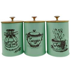 three green canisters with tea and coffee images on the front, one is labeled sugar