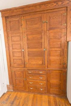 an old wooden armoire in a room