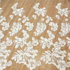 white floral lace fabric on wood flooring