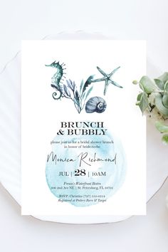 a white plate topped with a blue and green brunch and bubbly card