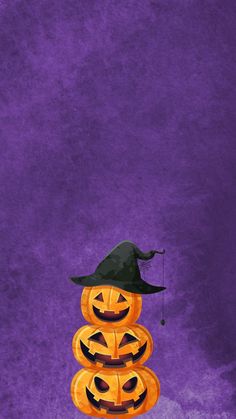 three pumpkins stacked on top of each other in front of a purple and purple background