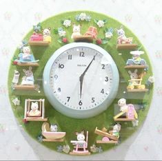 a green clock with many small toys on it