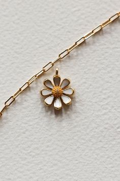 14k Gold filled enamel white daisy flower charm is sweet and happy. Add some joy to your charm necklace with this cute bloom. Hand make your custom charm necklace in Laguna Beach or build your piece online through adding a base necklace and your selection of charms. Leave us a note on your order for any special requests. 14K gold filled Tarnish resistant Enamel Enamel Necklaces With Flower Charm And Pendant, Enamel Flower Pendant Necklace With Charm, Enamel Flower Pendant Necklace With Flower Charm, White Pendant Charms For Gifts, White Pendant Charms For Gift, Flower Charm Enamel Necklace, Floral Enamel Necklace With Flower Charm, White Dainty Pendant Charm, Enamel Flower Charm Necklace