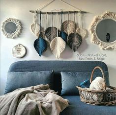 a bed with pillows and blankets on top of it next to two mirrors hanging from the wall