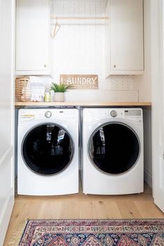 a washer and dryer in a laundry room with an area rug on the floor