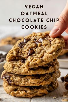 vegan oatmeal chocolate chip cookies stacked on top of each other with text overlay