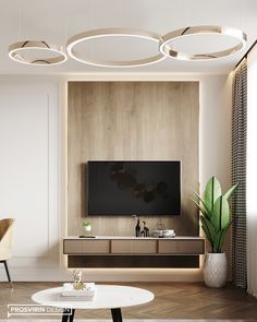 a living room with modern lighting fixtures and a flat screen tv mounted on the wall