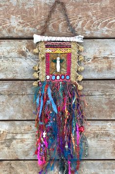 a colorful wall hanging on the side of a wooden building