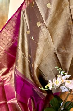 Experience the pure elegance of our handwoven Kanjivaram Silk Saree inspired by banarasi weaves. Crafted in a stunning khaki color, this saree features a deep purple border and grand pallu adorned with traditional motifs. The banarasi weave inspired morning and evening borders have traditional motifs in gold zari. This saree is a must-have for any formal event. Approximate Length 6.5 mtrs (inclusive of blouse length) Approximate Height - 48 - 52" Approximate weight - 1.7 lbs Saree comes with fall, picot and tassels done when applicable. Blouse piece is cut. Kindly Note : The colors you see on your device may vary due to the color reproduction, brightness and resolution of individual devices. If you'd like more clarity before your purchase, please contact our support team. Brown Dupatta With Traditional Patterns For Wedding, Brown Wedding Dupatta With Traditional Patterns, Wedding Brown Dupatta With Traditional Patterns, Brown Banarasi Silk Dupatta With Pallu, Brown Banarasi Silk Dupatta With Zari Weaving, Traditional Chanderi Wear With Zari Weaving In Brown, Brown Chanderi Traditional Wear With Zari Weaving, Traditional Brown Banarasi Silk Dupatta, Brown Saree With Traditional Patterns For Wedding