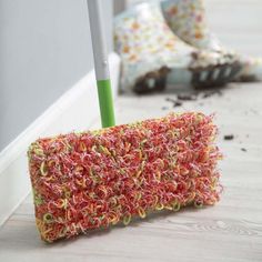 a mop laying on the floor next to a wall