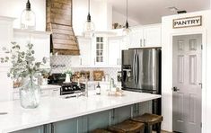 a kitchen with an island and stools in it