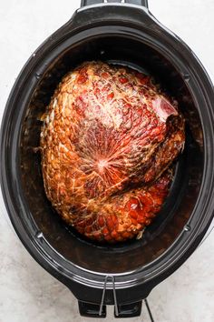 an uncooked meat is in the slow cooker and ready to be cooked