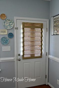 the door is open and there are plates hanging on the wall above the front door