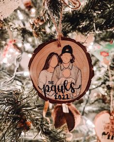 a wooden ornament hanging from a christmas tree with the words jesus and an image of a woman