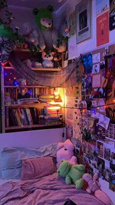 a bed with stuffed animals and pictures on the wall next to it in a bedroom