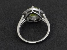 Welcome to my shop, you can find many beautiful gemstone jewelry here, and you also can ask for customized service. Main Stone: natural peridot, round cut 7X7mm, 1.39 carats. Accent Stones: cz Metal: 925 sterling silver plated with rhodium so as to protect the ring from tarnish and keep it shinning. I also can provide metal options such as 14k solid yellow/white/rose gold Setting: prong setting more rings: https://www.etsy.com/shop/XCjewelryStudio?ref=hdr_shop_menu It's quite comfortable for wea Green Diamond Ring With Halo, Green Diamond Halo Ring In Round Cut, Green Cubic Zirconia Diamond Ring With Halo Design, Green Diamond Ring With Halo Setting, Green Halo Jewelry With Round Cut, Green Halo Design Round Jewelry, Green Halo Round Cut Jewelry, Round Peridot Jewelry With Halo Setting, Green Halo Ring Jewelry