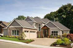 a large house with two garages on the front and one car in the driveway